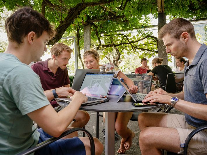 A team of students working on their laptops